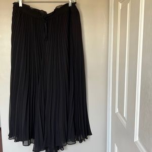 Black pleated culottes.